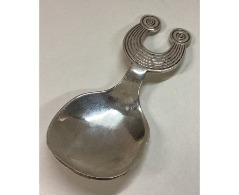 An Irish silver contemporary caddy spoon of unusual shape. Approx. 33 grams. Est. £40 - £60.