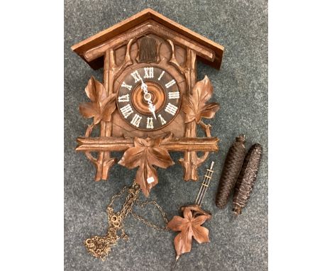 An old carved cuckoo clock. Est. £30 - £50.