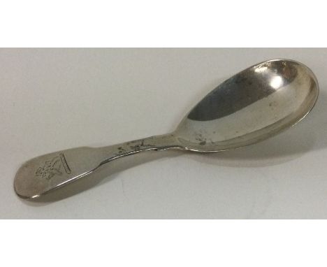 A George III silver crested caddy spoon. London 1819. By William Bateman. Approx. 16 grams. Est. £50 - £80.