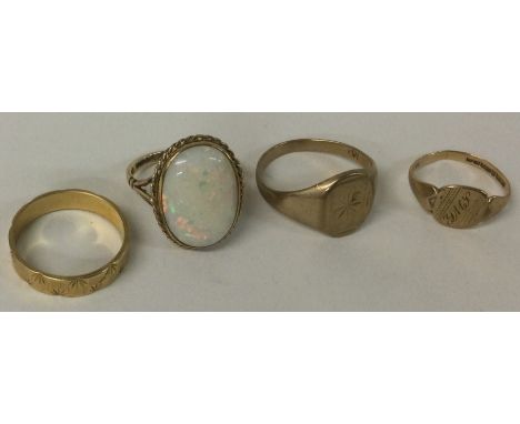 An opal single stone ring together with three other gold bands. Approx. 12 grams. Est. £100 - £150.