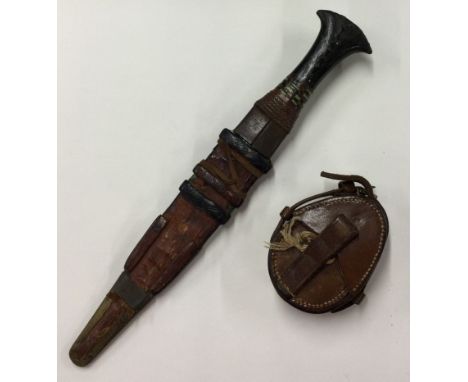 An old brass mounted compass together with a dagger. Est. £20 - £30.