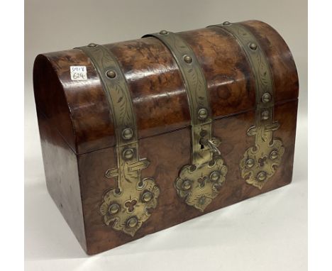 A domed top and brass mounted tea caddy. Est. £20 - £30.
