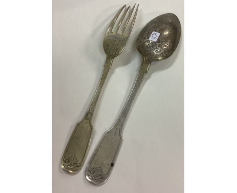 A mid 19th Century silver fork and spoon. Approx. 120 grams. Est. £120 - £150.