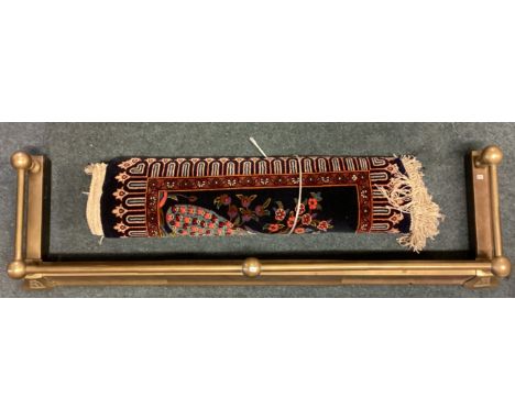 A small brass fender together with a tapestry rug. Est. £20 - £30.