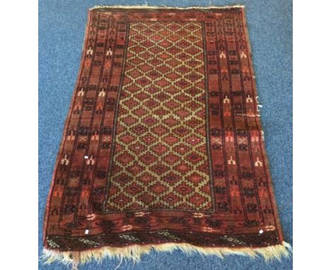 An old tapestry rug in red ground. Approx. 86 cms x 140 cms. Est. £20 - £30.