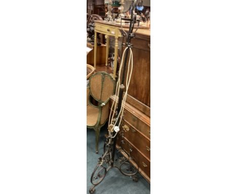 A decorative wrought iron standard lamp. Est. £30 - £50.