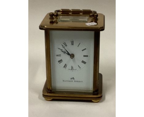 A small brass carriage clock with white enamelled dial. Est. £30 - £40.