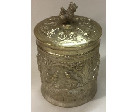 An Indian metalware tea caddy embossed with figures. Est. £30 - £50.