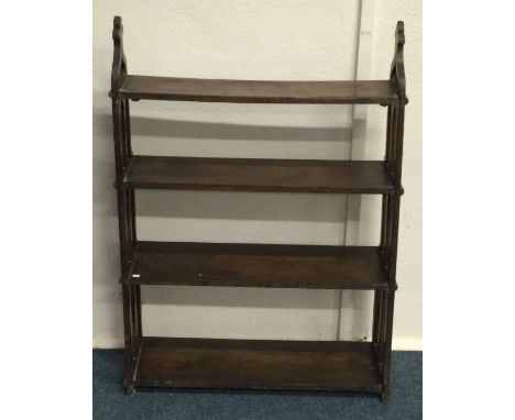 A carved oak wall shelf of gothic design. Est. £20 - £30.