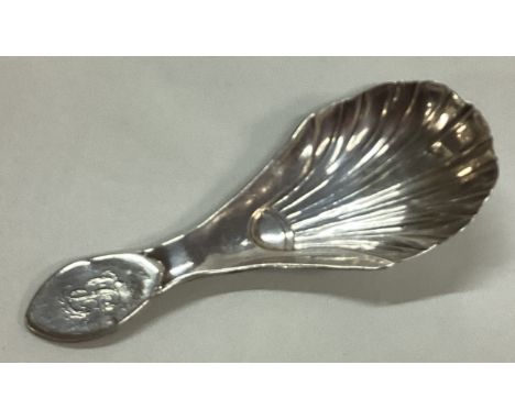 A George III silver fluted caddy spoon. Approx. 10 grams. Est. £30 - £50.