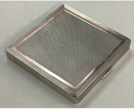 A heavy silver and gold inlaid compact. Birmingham 1955. By WH Manton Ltd. Approx. 172 grams. Est. £120 - £150.