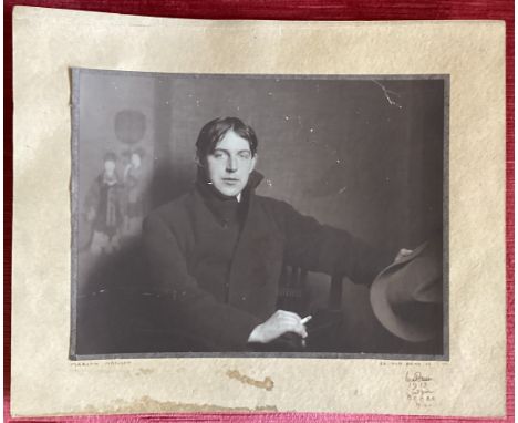 MARION NEILSON: (British, 1875 - 1965): A black and white photograph print of Claud Lovat Fraser holding a hat and a cigarett