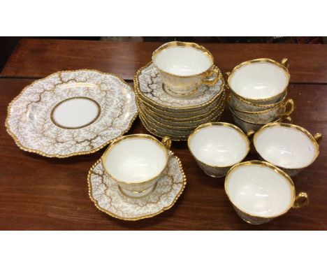 A Flight, Barr & Barr Worcester part tea service with gilt seaweed pattern. Est. £20 - £30.