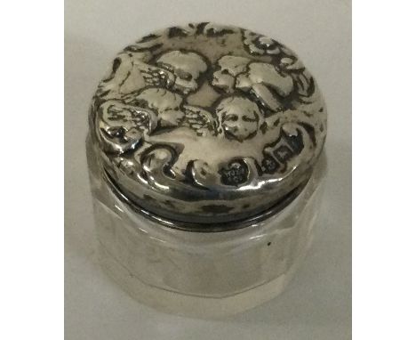 A silver and glass box decorated with cherubs. Birmingham 1901. Est. £20 - £30.