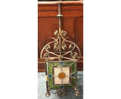 A wrought iron and stained glass lamp. Est. £40 - £50.