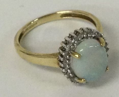 An opal and diamond cluster ring set in 9 carat mount. Approx. 2.6 grams. Est. £50 - £80.