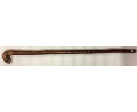 An unusual tapering walking stick in the form of a dog. Est. £20 - £30.