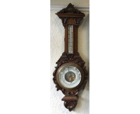 A good carved oak barometer. Est. £60 - £80.