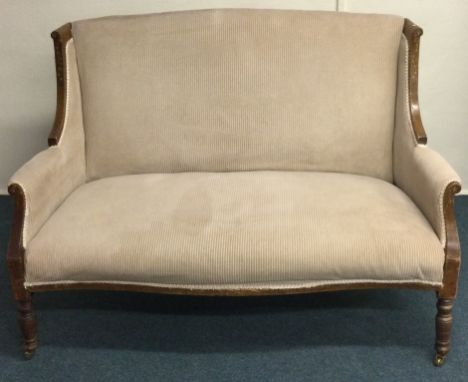 A Victorian scroll edge sofa on turned supports. Est. £30 - £50.