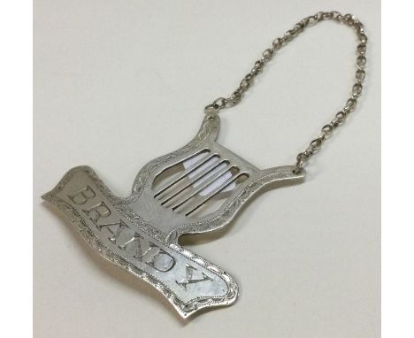 A silver wine label for 'Brandy' in the shape of a harp. Approx. 9 grams. Est. £20 - £30.