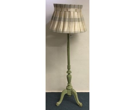 A painted green standard lamp. Est. £20 - £30.
