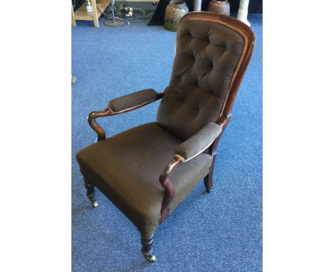 A Victorian button back arm chair with shaped arms. Est. £30 - £50.