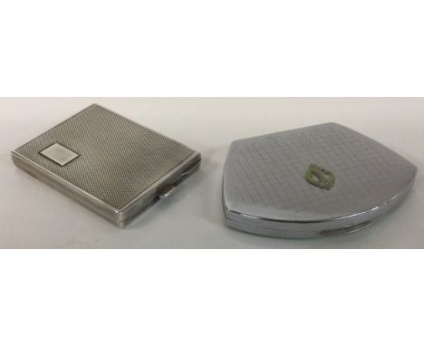 A silver mounted compact together with one other. Approx. 65 grams. Est. £20 - £30.