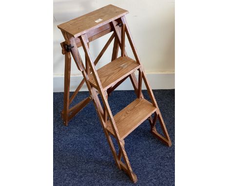 A retro wooden and iron mounted step ladder. Est. £20 - £30.