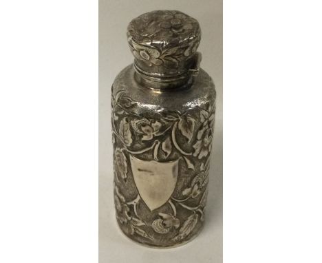 A Victorian chased silver scent bottle with glass stopper embossed with flowers. Birmingham 1869. Approx. 77 grams. Est. £100