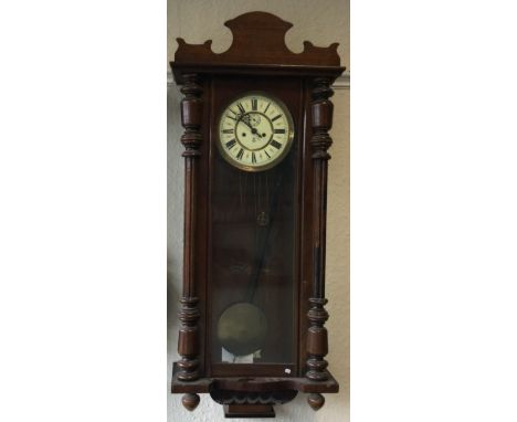A large mahogany mounted wall clock. Est. £30 - £50.