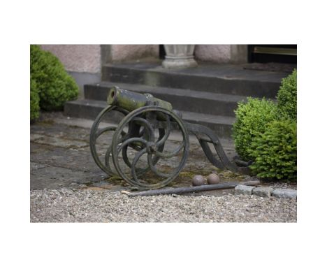 PATINATED CAST IRON CARRONADECIRCA 1800raised on later open carriage base, fitted with two large wheels with carved spokes, w