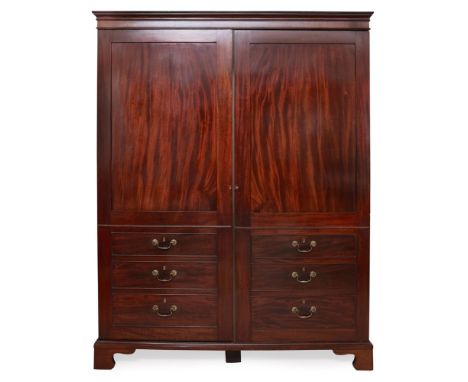 GEORGE III MAHOGANY WARDROBE18TH/ EARLY 19TH CENTURYwith panelled doors above six faux short drawers with brass 'handles', ra