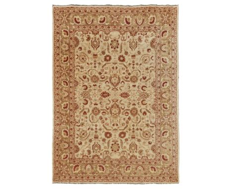 ZEIGLER STYLE CARPETMODERNthe cream field with stylised palmettes and foliage in red, pink and green, within a light brown pa