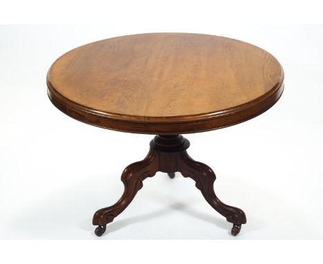 A mid 19th century mahogany round centre of breakfast table with plain top on a frieze raised on a turned baluster column on 