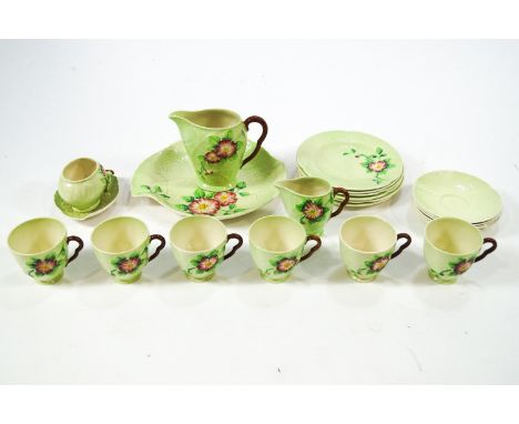 A Carlton ware tea service comprising six cups and saucers, six tea plates, two jugs, a serving plate and sugar bowl with sau