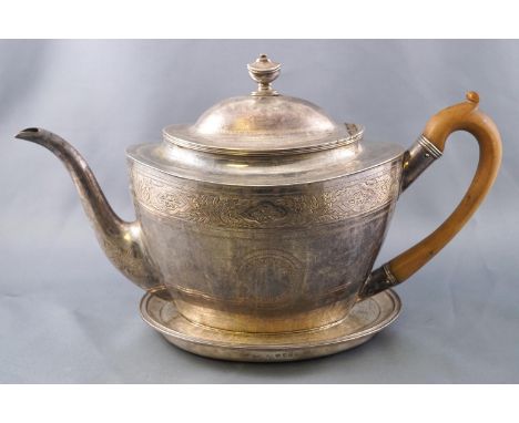 A bright cut silver teapot of oval form with plain domed lid set an urn finial, the body decorated with a band of floral and 