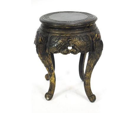 A Chinese style carved wood jardiniere stand, painted black, on four scroll legs, 52cm high and top 36cm diameter