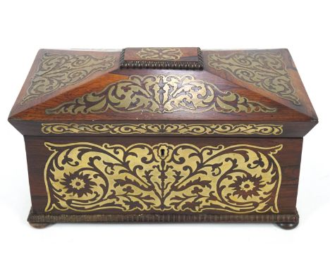 A Regency rosewood and brass inlaid tea caddy, the sarcophagus shaped top opening to reveal two tea cannisters flanking an en