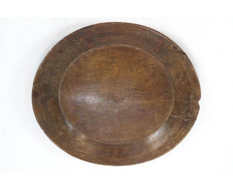 A 19th century hardwood charger, 52cm x 48cm and a poplar dough trough with wrought iron supports, 99cm x 37cm