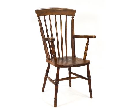 A 19th century stick back elbow chair with elm solid seat on turned legs