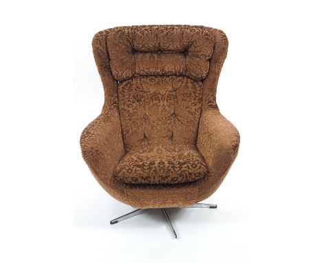 A mid century swivel chair, with button back and seat in pressed brown velvet style fabric, raised on a splayed metal central