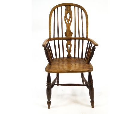 Two Windsor chairs, with bentwood rail and arms, stick back set with a central pierced splat on an elm seat and turned stretc
