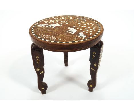 An Indian teak coffee table inlaid with camel bone and ebony with a central panel of the Taj Mahal and two elephants feeding 