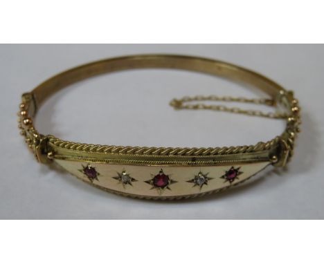 UNHALLMARKED YELLOW METAL SNAP BANGLE SET WITH RUBY COLOURED STONES AND CLEAR STONES (RESTORED)