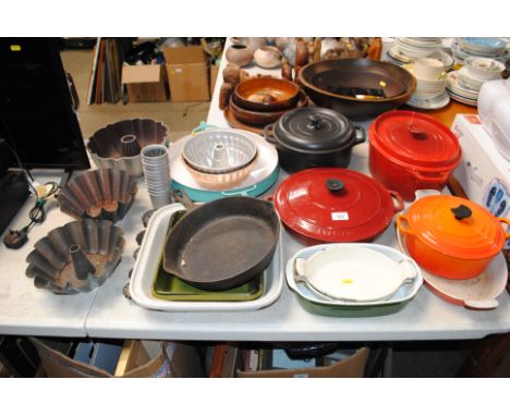 A collection of Le Creuset and other cooking dishes and moulds etc 