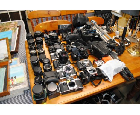 A Cannon EOS 1000F camera and various vintage cameras including Praktica with various lenses and accessories 