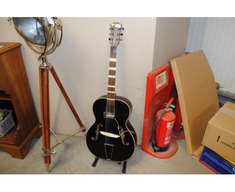 A Hohner guitar and stand