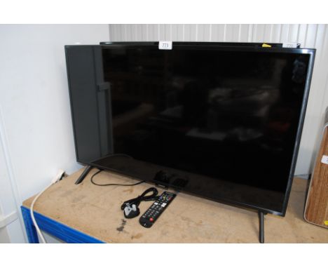 A Samsung QE32Q50AEU flat screen television with remote control