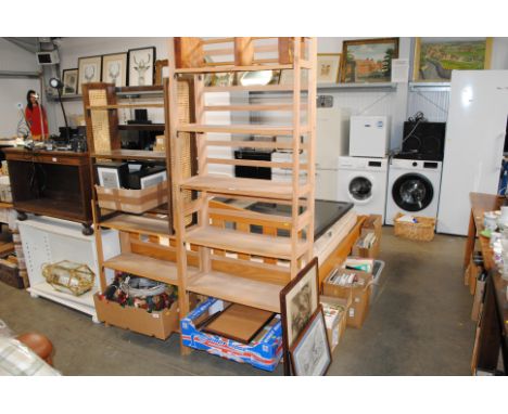 Three folding shelves, a cane sided folding shelf and a carved wooden book rack