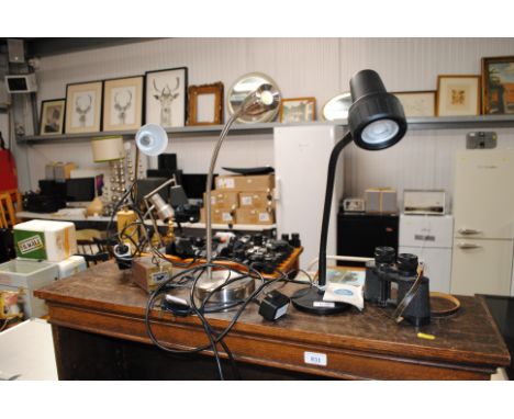 A pair of Carl Zeiss binoculars, a serious readers adjustable reading light and one other adjustable reading light and a Tens